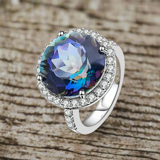 Ring with a colorful gemstone and diamond accents on a white background, featuring the brand 'Gem's Ballet'.