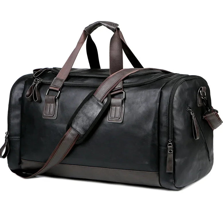 Black leather duffel bag with brown straps on a white background