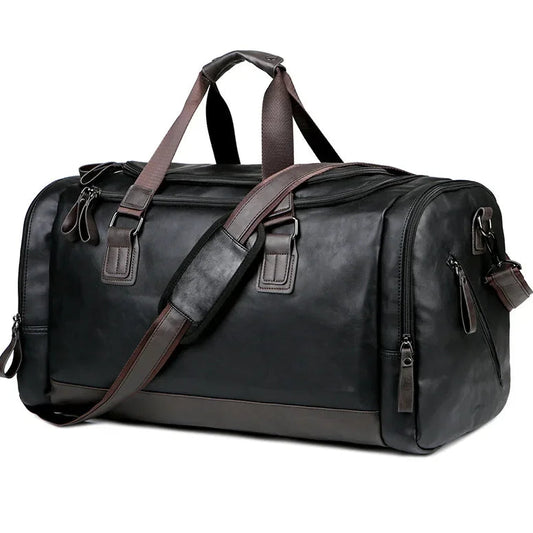 Black leather duffel bag with brown straps on a white background