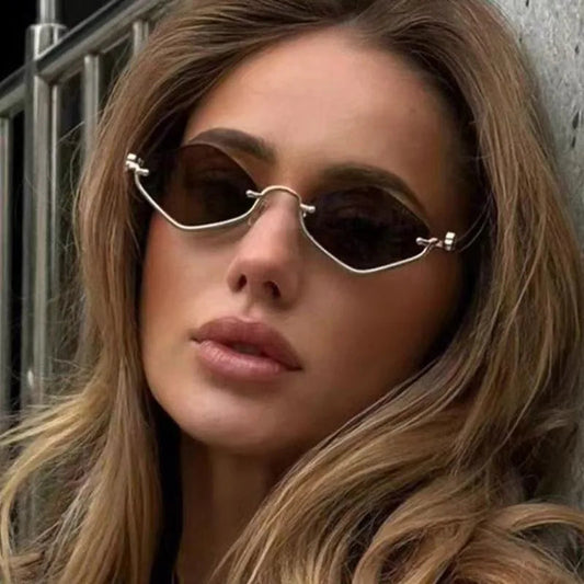 Close-up of a person wearing small sunglasses with a neutral background