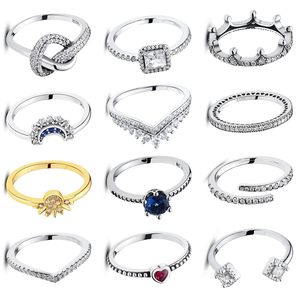 Collection of various silver and gold rings on a white background