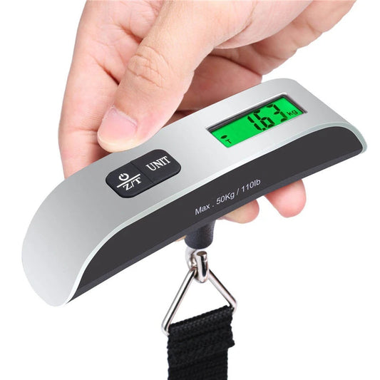 Digital luggage scale held by a hand with a white background