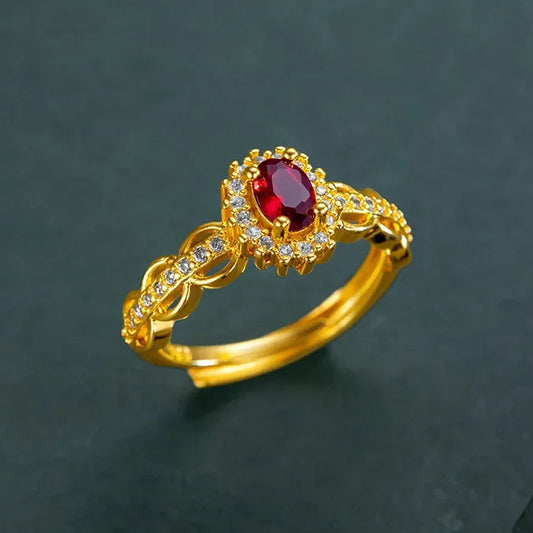 Gold ring with a red gemstone on a dark background