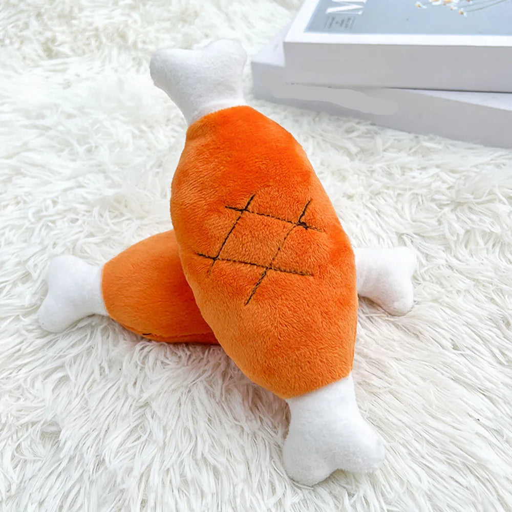 Plush toy resembling a carrot on a white fluffy surface