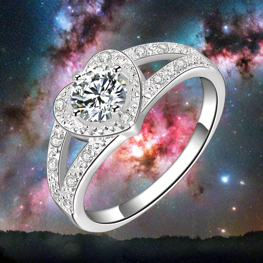 Silver ring with a large central gemstone and smaller stones on a white background

