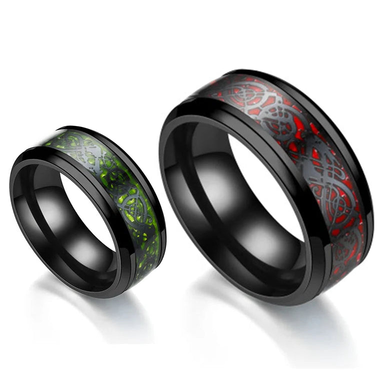 Two black-rimmed rings with red and green inlays on a white background