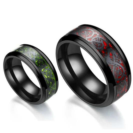 Two black-rimmed rings with red and green inlays on a white background